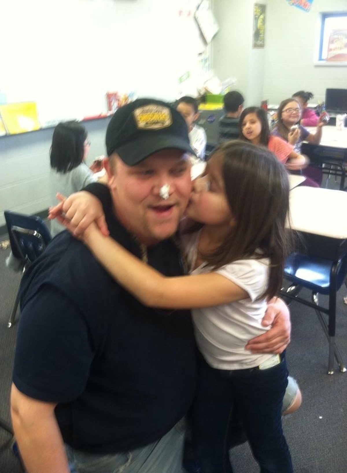 Elizabeth kissing Ben on the cheek at a school event
